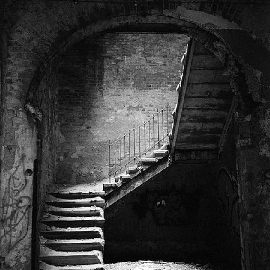 Although this abandoned hospital is in Beelitz Heilstaetten, Germany, in my mind Kelby is guided to the bottom of a rotting wooden stairway. This one is stone but also see the image of the skylight. I love how the light filters down but still gives such an eerie feeling ...