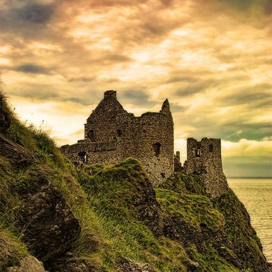 Dunluce Castle, County Antrim, Northern Ireland was my inspiration for a vivid scene setting, yet I wanted it to be in Scotland on Columbus Island to fit into my 'Columbus' theme in The Sacred Symbol.